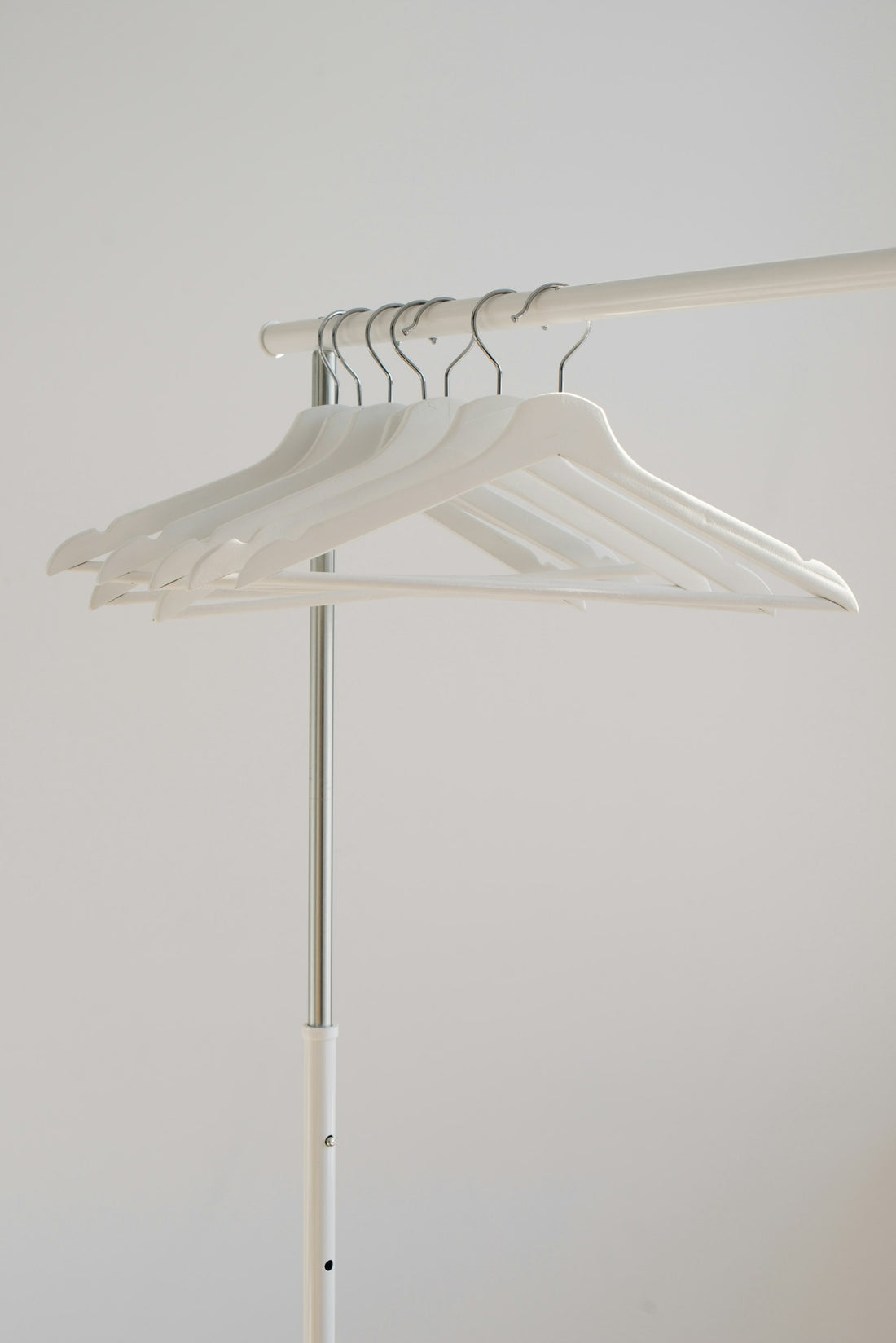 White clothes hanging neatly on a rack