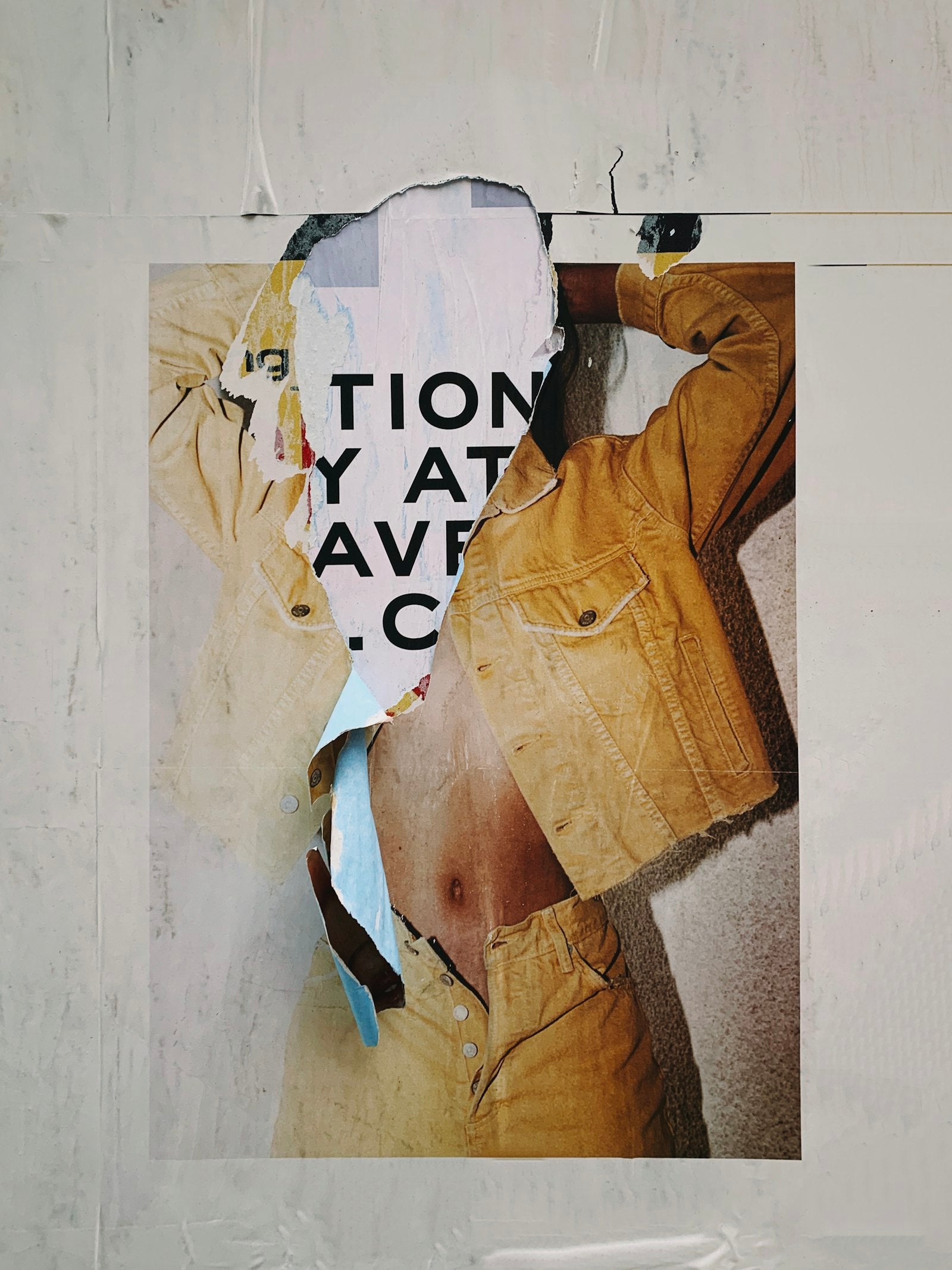 Torn poster peeling off a wall, symbolizing rebellion and street culture