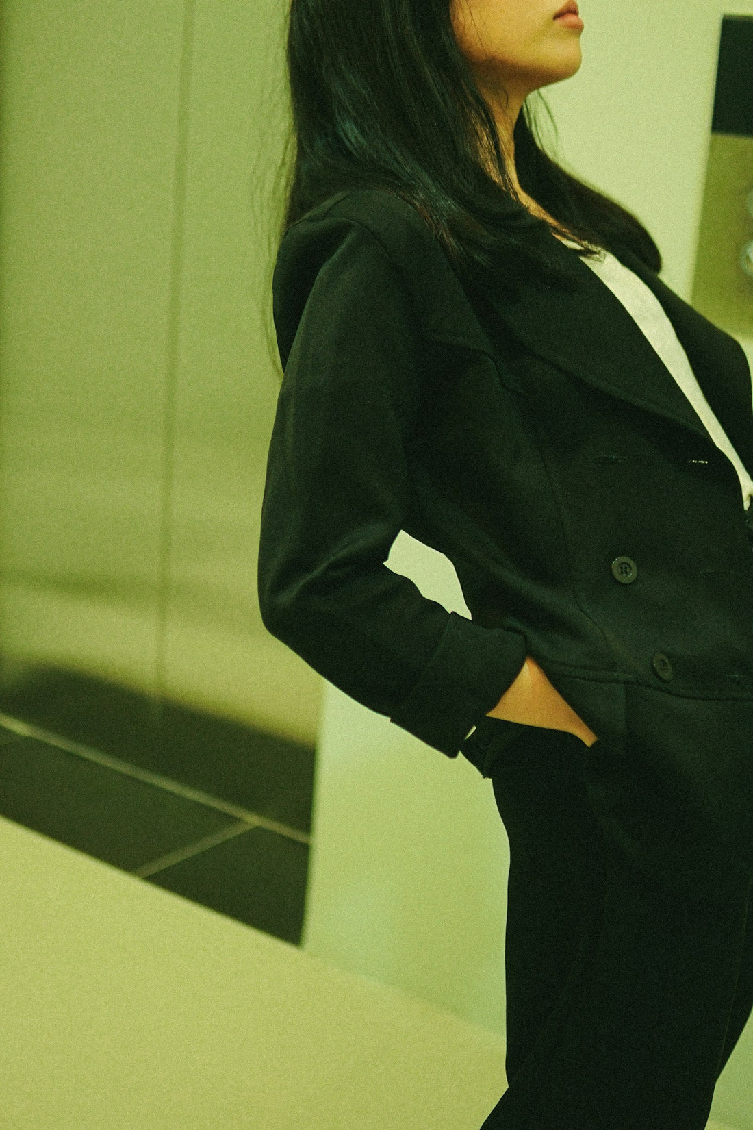 Person standing in a minimalist black outfit